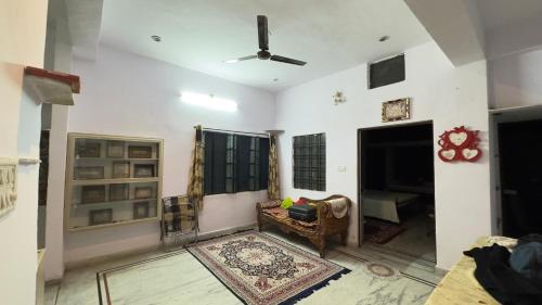 a living room with a couch and a ceiling fan at Hardik villa in Udaipur