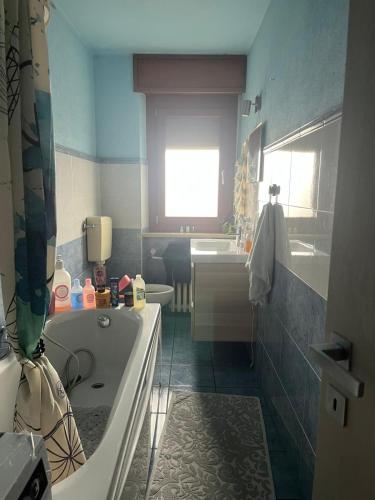 a bathroom with a tub and a sink at San Francisco in Borgo San Dalmazzo