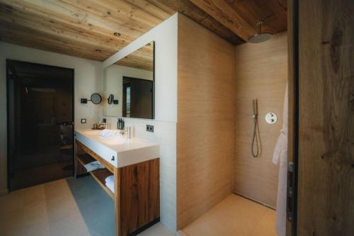 a bathroom with a sink and a mirror at Hotel am Hopfensee in Füssen
