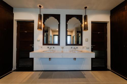 a bathroom with two sinks and two mirrors at Villa 18 Kata-Private Pool Villa with Sea View in Ban Kata