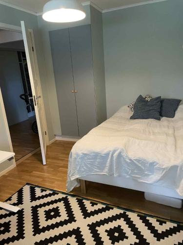 a bedroom with a bed with a black and white rug at Bergnäset in Luleå