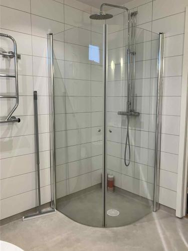 a shower with a glass door in a bathroom at Bergnäset in Luleå