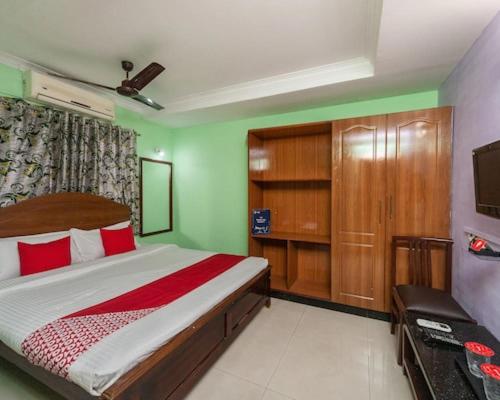 a bedroom with a large bed and a television at Hotel Pleasure Palace in Indore