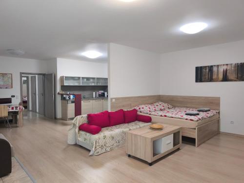 a living room with a couch and a bed at Apartmán Kurdějov in Hustopeče