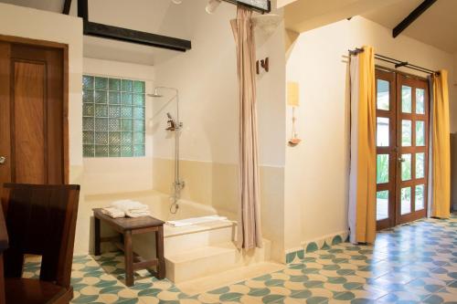 a bathroom with a shower and a tub at Sambor Village Hotel in Kompong Thom