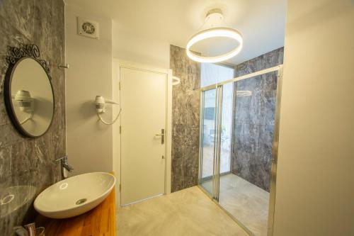 a bathroom with a sink and a mirror at poseidon kınalıada in Kınalıada