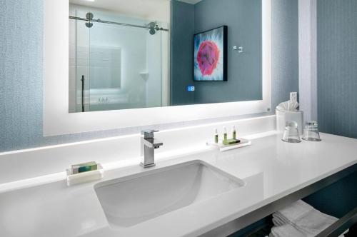 a bathroom with a white sink and a mirror at Cambria Hotel Phoenix Chandler - Fashion Center in Chandler