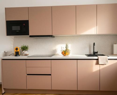 a kitchen with white cabinets and fruits on the counter at Villa Jahn in Baden