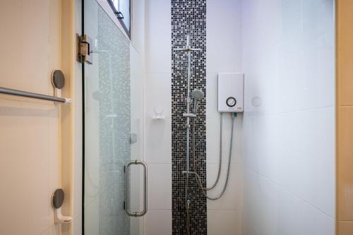 a bathroom with a shower with a glass door at Saree Lagoon Villa Koh Samui in Lipa Noi