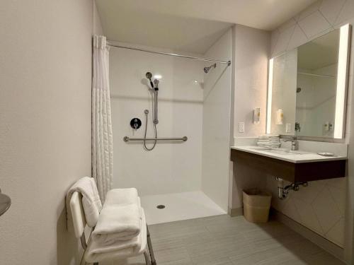 a white bathroom with a shower and a sink at Comfort Inn & Suites Sturbridge-Brimfield in Sturbridge