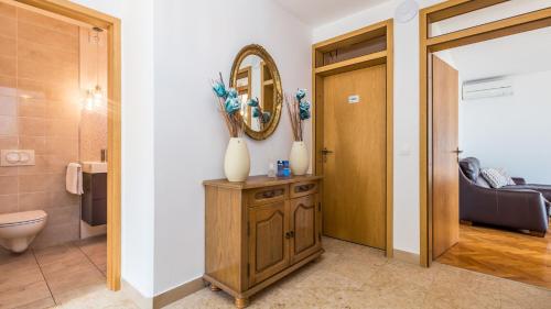 a bathroom with a toilet and a mirror at Vila Iris - Opatija by Villas Guide in Breza
