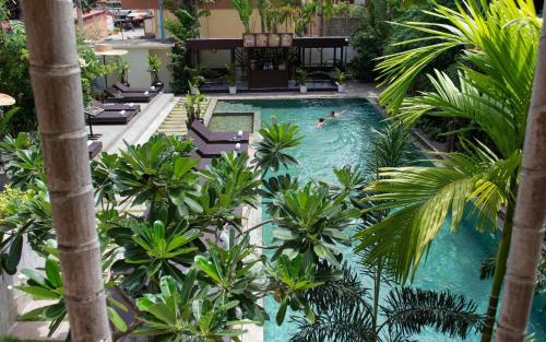 an overhead view of a swimming pool with palm trees at Serenity Boutique in Siem Reap
