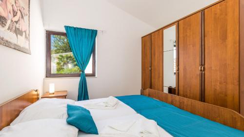a bedroom with a large bed and a window at Vila Iris - Opatija by Villas Guide in Breza