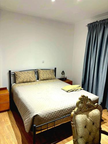 a bedroom with a bed and a blue curtain at Maria House in Kefalos