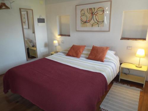 a bedroom with a large bed and a mirror at Studio in Tuscan farmhouse with pool in Monteguidi