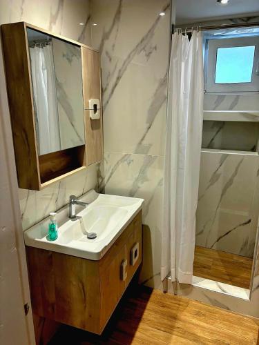 a bathroom with a sink and a mirror and a shower at Maria House in Kefalos