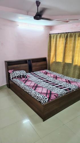 a bed sitting in a room with aintendent at Gem Backpackers Hostel in Siliguri