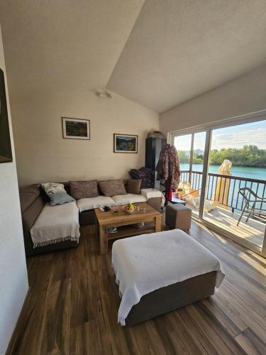 a living room with a couch and a table at Holiday home Ramovic in Virpazar
