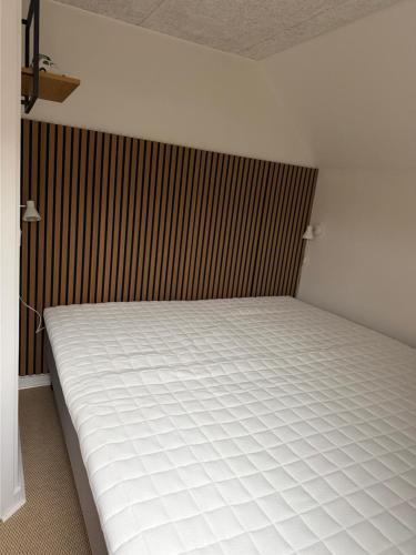 a bed in a room next to a wall at BBL59 in Faaborg