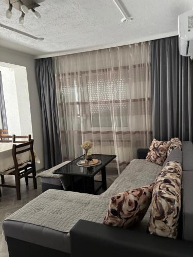 a bedroom with a bed and a table and a couch at Flat in Trpejca in Ohrid