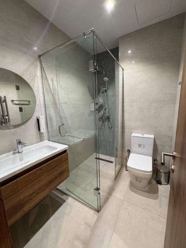 a bathroom with a shower and a toilet and a sink at Imam Bukhari Grand Hotel in Khodzha-Ismail