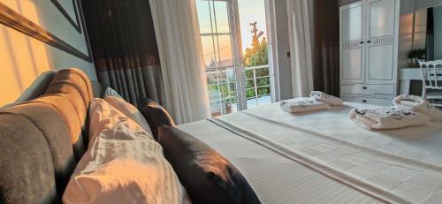 a bedroom with a bed and a large window at PRETTY HOUSE in Pamukkale
