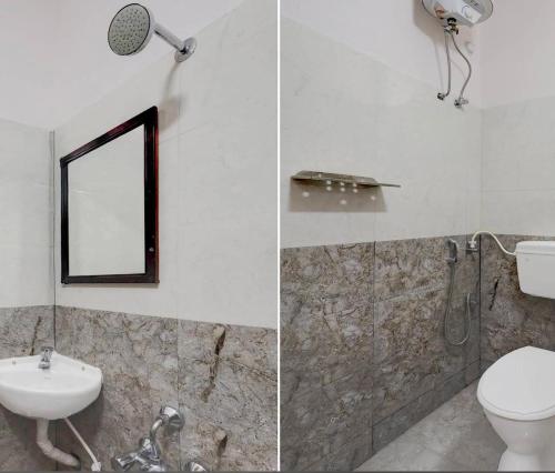 a bathroom with a toilet and a sink and a mirror at Embassy Gate Residency - opp US Embassy in Chennai
