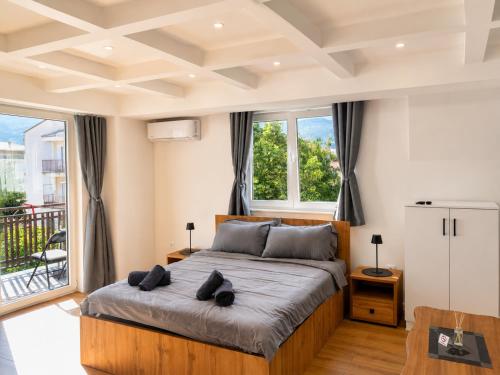 a bedroom with a large bed and a balcony at Luxury Apartment Poli in Ohrid