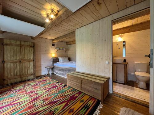 a bedroom with a bed and a bathroom with a rug at Breb 220D in Breb