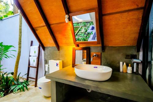 a bathroom with a sink on top of a counter at Taro River Resort Negombo in Otarawadiya
