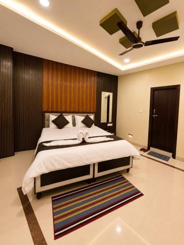a bedroom with a bed and a ceiling fan at Hotel Balaji Inn in Raipur
