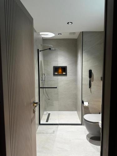 a bathroom with a shower and a toilet at Göcek Lykia Resort Premium Concept Hotel in Göcek