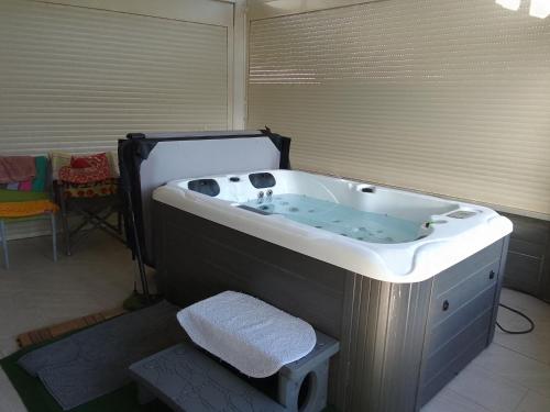 a large bath tub in a room at La Basse Plagne in Feytiat