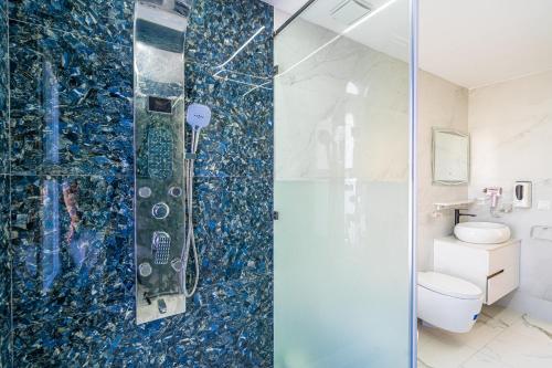 a bathroom with a glass shower with a toilet at Villa 33 Ultra Lux High-End in Tangier