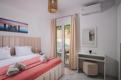 a bedroom with a bed and a desk and a window at Moonlit Villa in Planos