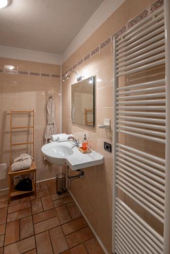 a bathroom with a sink and a mirror and a shower at Eremo della Gasprina in La Morra