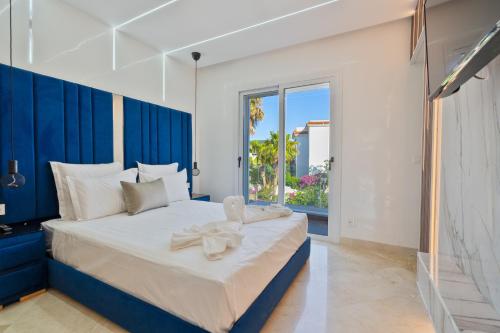 a bedroom with a large bed with a blue headboard at Villa 33 Ultra Lux High-End in Tangier