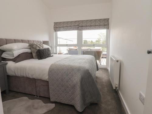 a bedroom with a bed and a large window at Apartment 20, River View in Preston