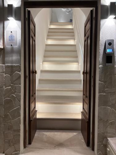 a set of stairs in a building with open doors at Borgo Bianco in Vieste