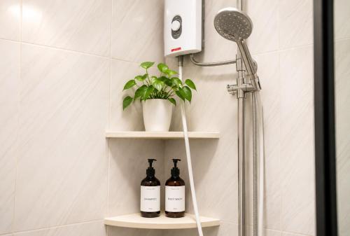a bathroom with two bottles of wine on a shelf at Sky Garden Homestay in Olongapo