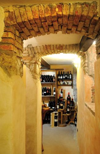 a room with a stone wall and a wine cellar at Hotel Regina in Alassio