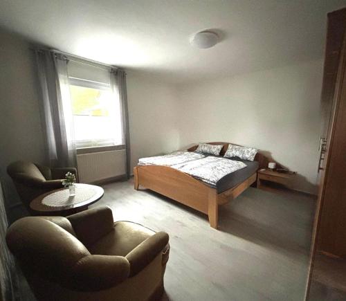 a bedroom with a bed and a couch and a table at Ferienwohnung Schöne Aussicht in Nieheim