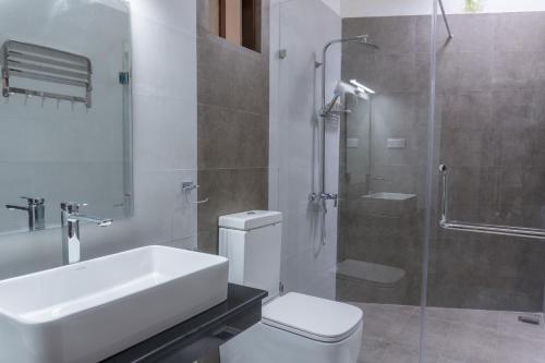 a bathroom with a toilet and a sink and a shower at Ditara in Katugastota