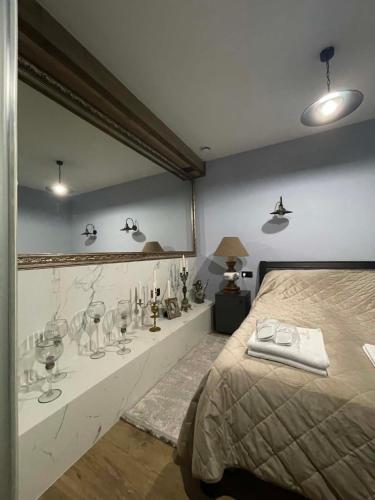 a bedroom with a bed and a shelf with wine glasses at Villa Rinat in Kyiv