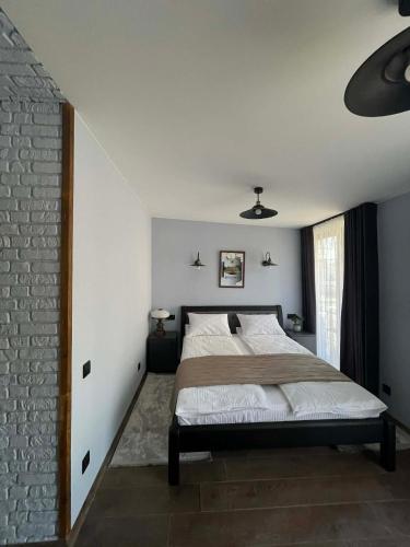 a bedroom with a bed and a brick wall at Villa Rinat in Kyiv