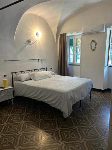 a bedroom with a bed in a room with a ceiling at Cà Bartolomeo in Finale Ligure