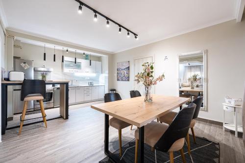 a kitchen and dining room with a wooden table and chairs at Villa Dorotea in Tivat
