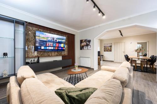 a living room with a couch and a tv at Villa Dorotea in Tivat