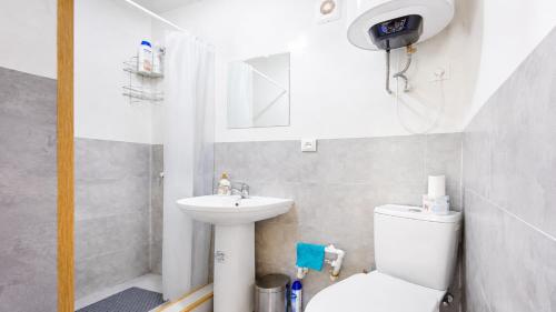 a small bathroom with a toilet and a sink at Ushguli Cabins l Cafe in Ushguli