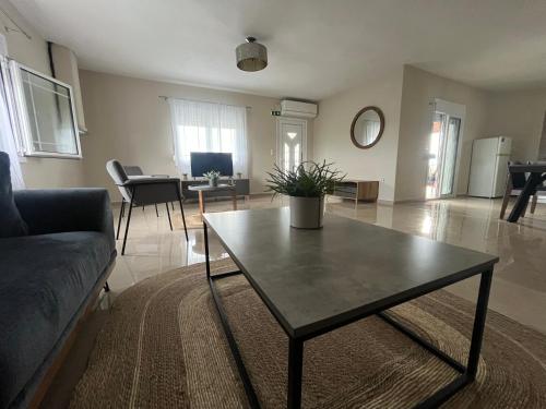 a living room with a table and a couch at Sky Apartment in Ofrínion